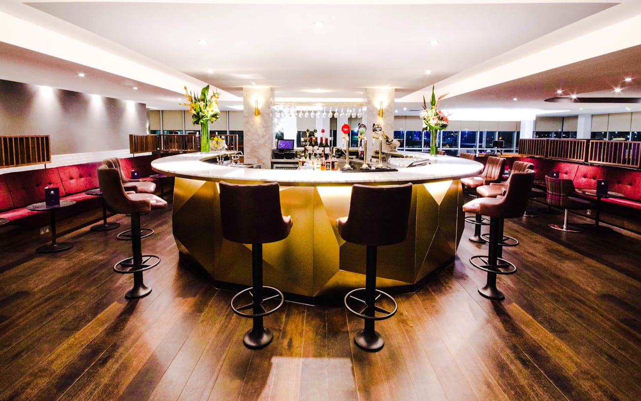 Gatwick Airport Lounge North Terminal bar area with seating and floral decor.