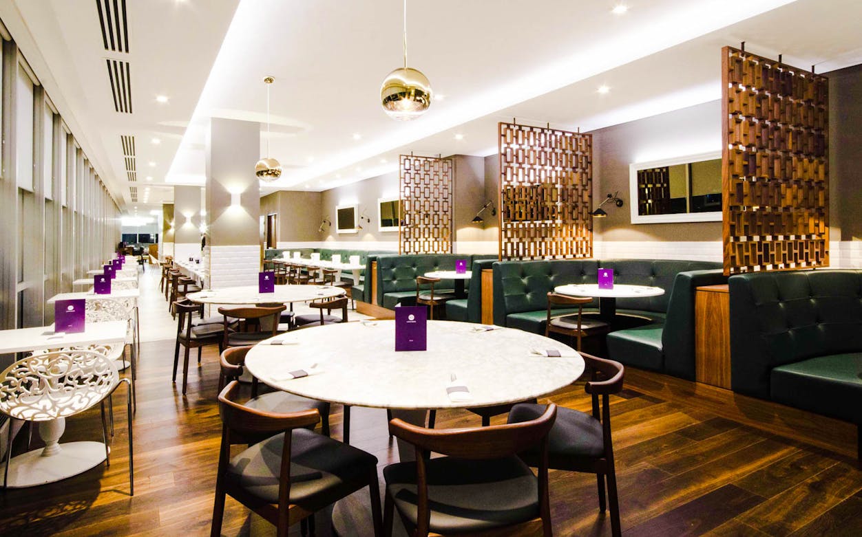 Gatwick Airport Lounge North Terminal seating area with tables and chairs.