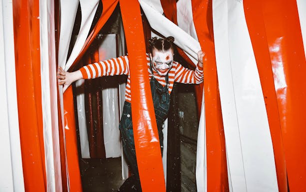 Performer in clown makeup at The London Bridge Experience attraction.