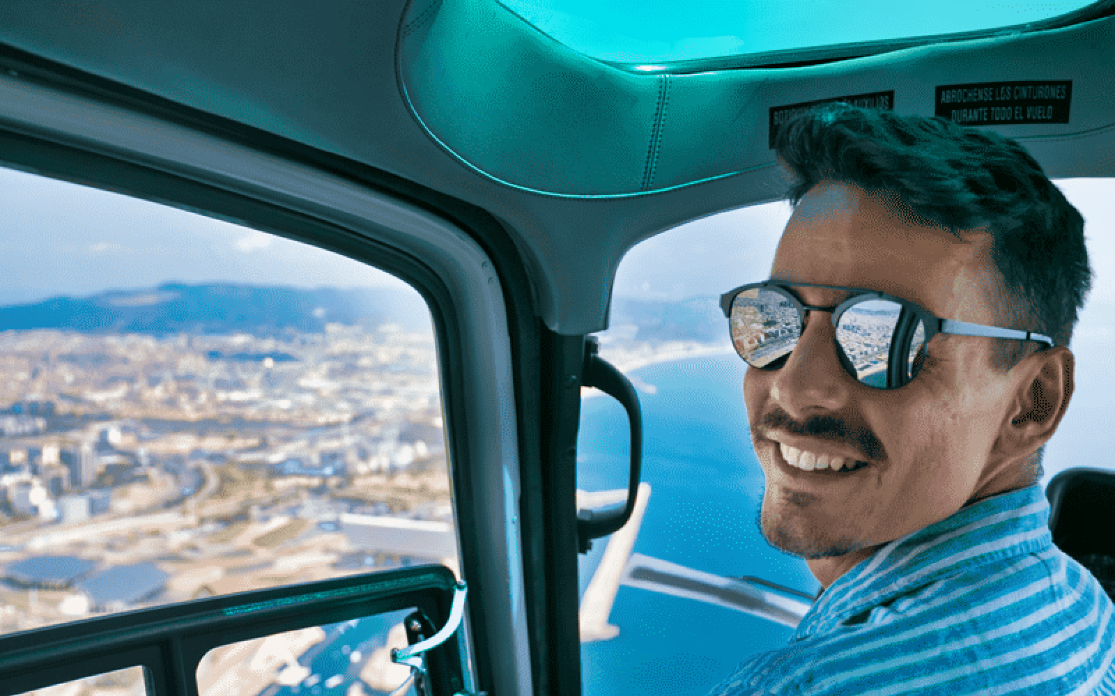 Helicopter view of Barcelona coastline during a scenic flight tour.