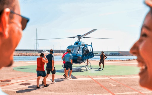 Tourists boarding a helicopter for a scenic flight in Barcelona.