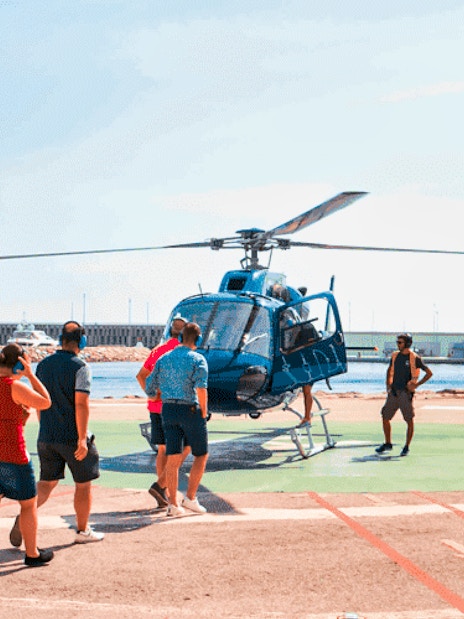 Tourists boarding a helicopter for a scenic flight in Barcelona.