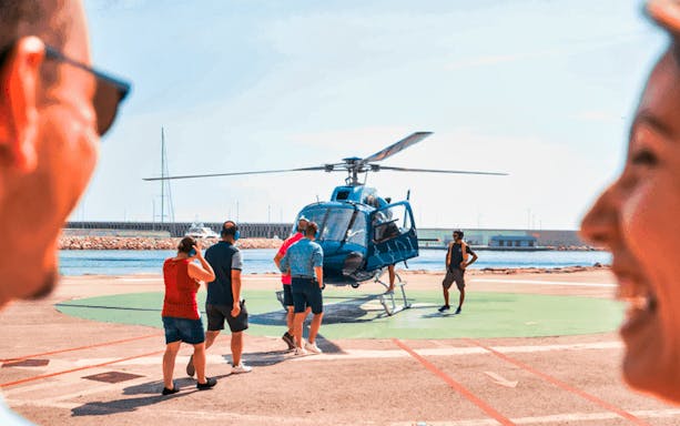 Tourists boarding a helicopter for a scenic flight in Barcelona.