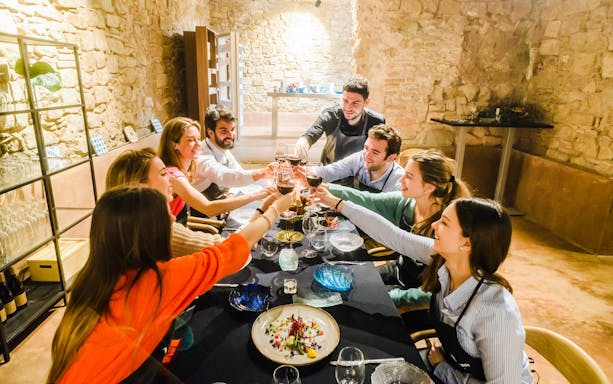 Chef preparing tapas at a cooking show in Barcelona, featuring vanguardist tapas dinner and cocktail experience.