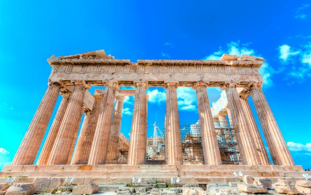 Parthenon temple on the Acropolis in Athens under a clear blue sky.
