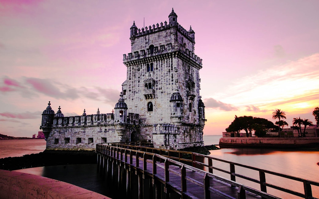 Belem Tower at sunset in Lisbon, Portugal, part of the Lisbon Card and Hop-On Hop-Off Bus Tour.