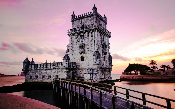 Belem Tower at sunset in Lisbon, Portugal, part of the Lisbon Card and Hop-On Hop-Off Bus Tour.
