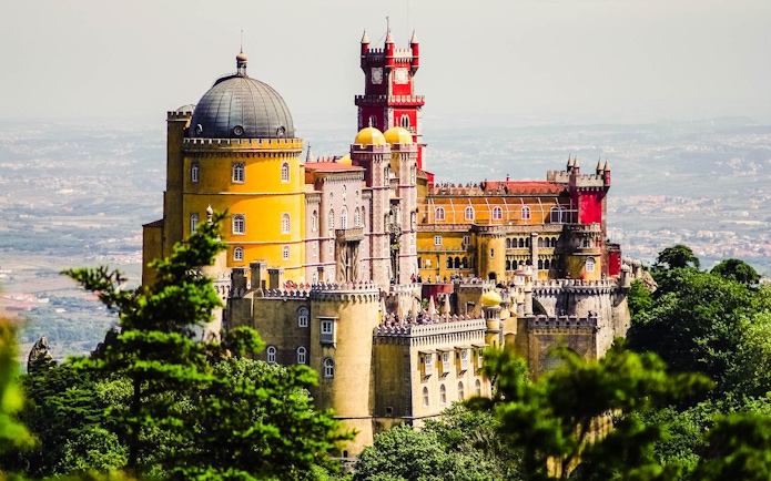 Pena Palace in Sintra, Portugal, viewed from a distance, part of Lisbon Card + Hop-On Hop-Off Bus Tour.