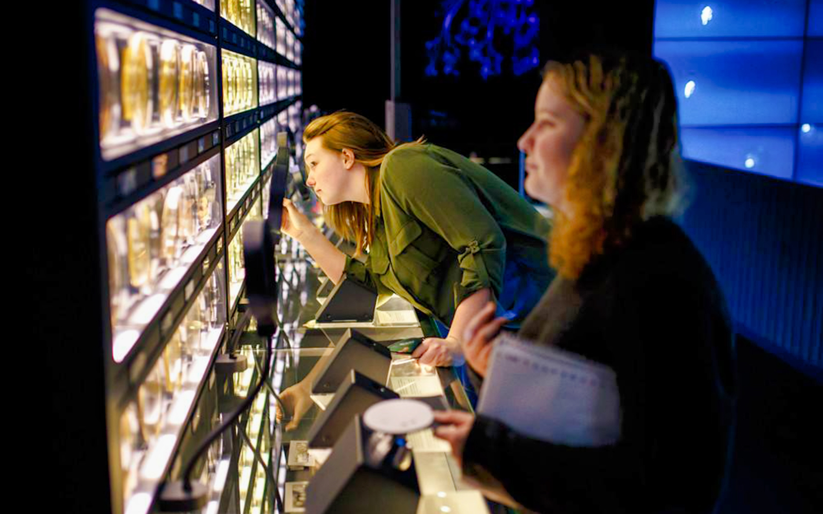 Visitors examining microbial exhibits at Micropia Amsterdam.