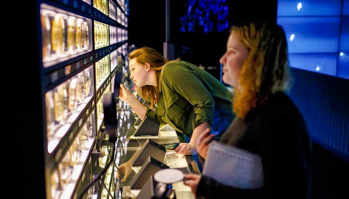 Visitors examining microbial exhibits at Micropia Amsterdam.