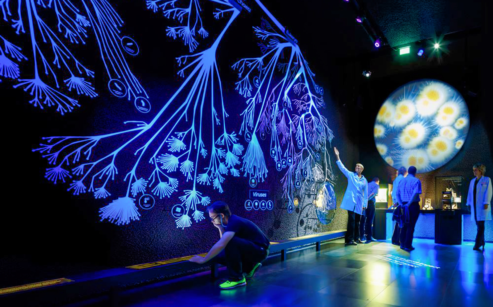 Interactive exhibit at Micropia Amsterdam with visitors exploring microorganisms.