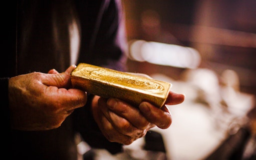Hands holding a gold bar at Sovereign Hill.