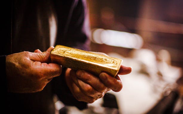 Hands holding a gold bar at Sovereign Hill.