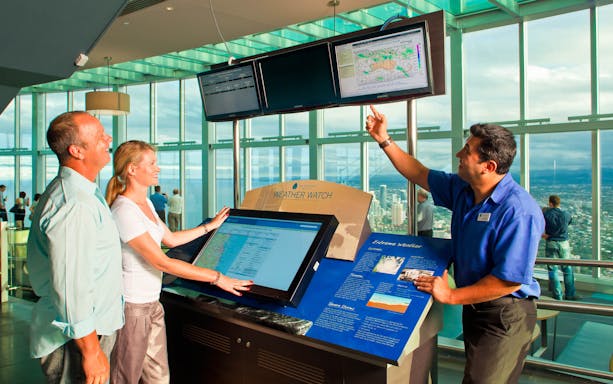 Visitors exploring interactive weather display at Skypoint, Gold Coast.