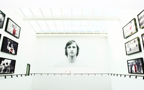 Football museum gallery with large portrait and action shots of players.