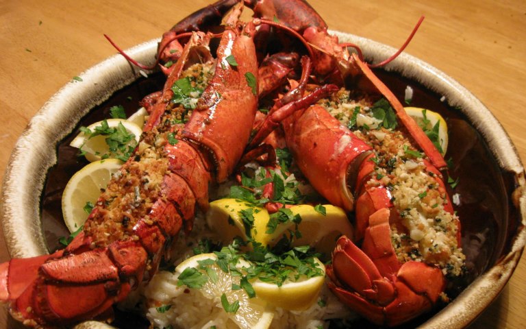 Lobster dinner with lemon wedges on a plate for Pedicab Tour.