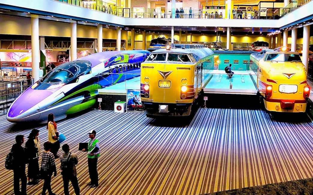 Kyoto Railway Museum trains display with visitors exploring exhibits.