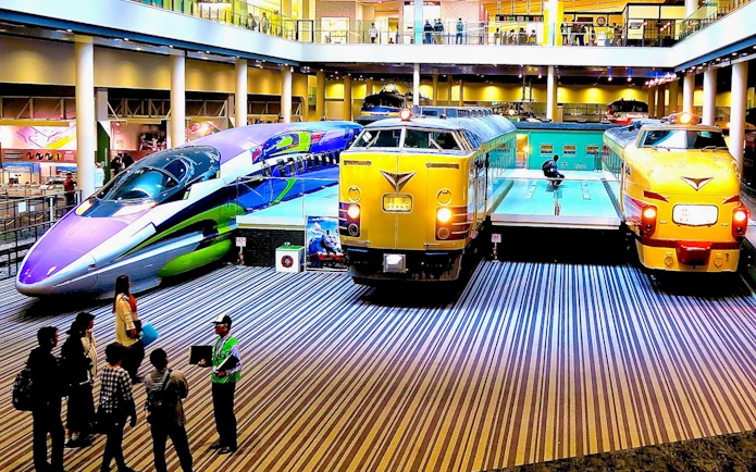 Kyoto Railway Museum trains display with visitors exploring exhibits.
