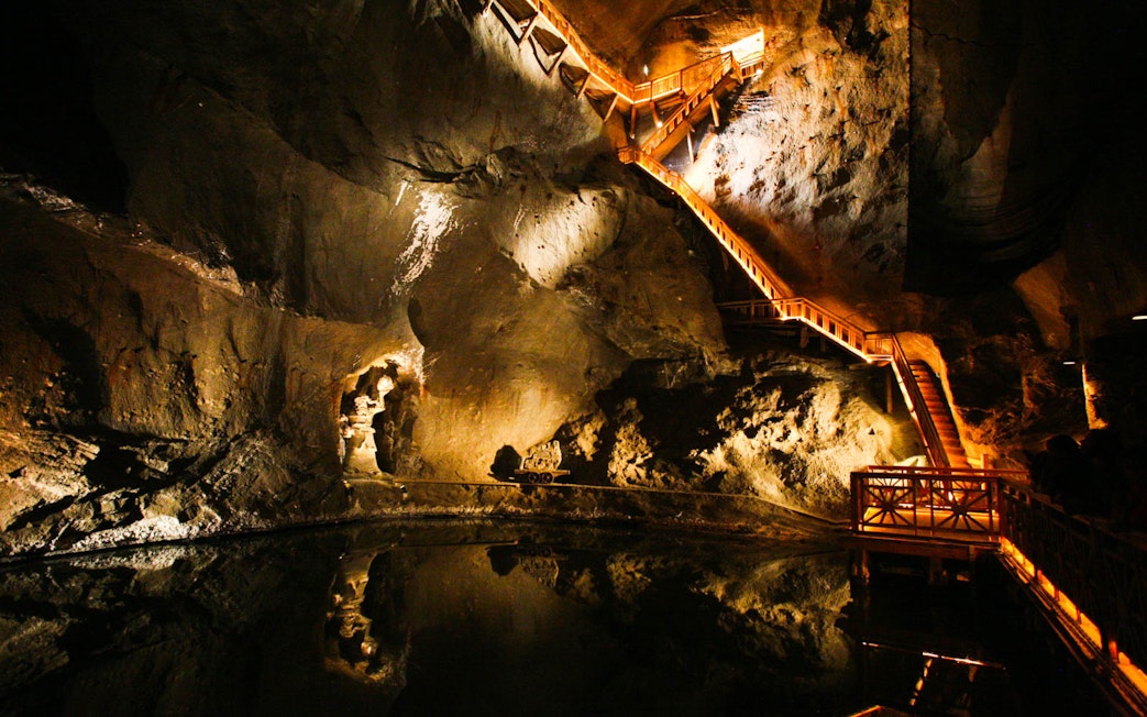 Wieliczka Salt Mine illuminated staircase and underground lake on guided tour.