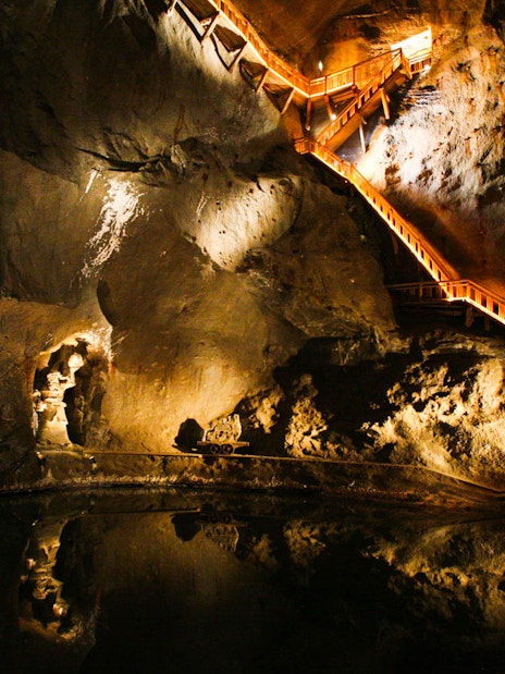 Wieliczka Salt Mine illuminated staircase and underground lake on guided tour.
