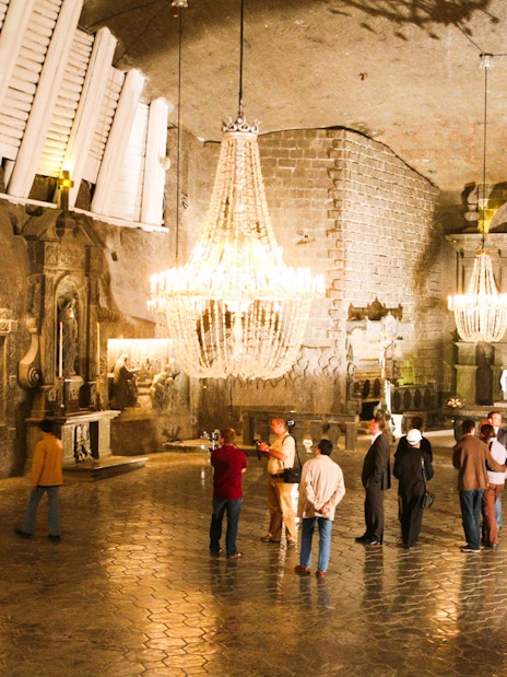 Visitors exploring the ornate chapel inside Wieliczka Salt Mine on a guided tour.