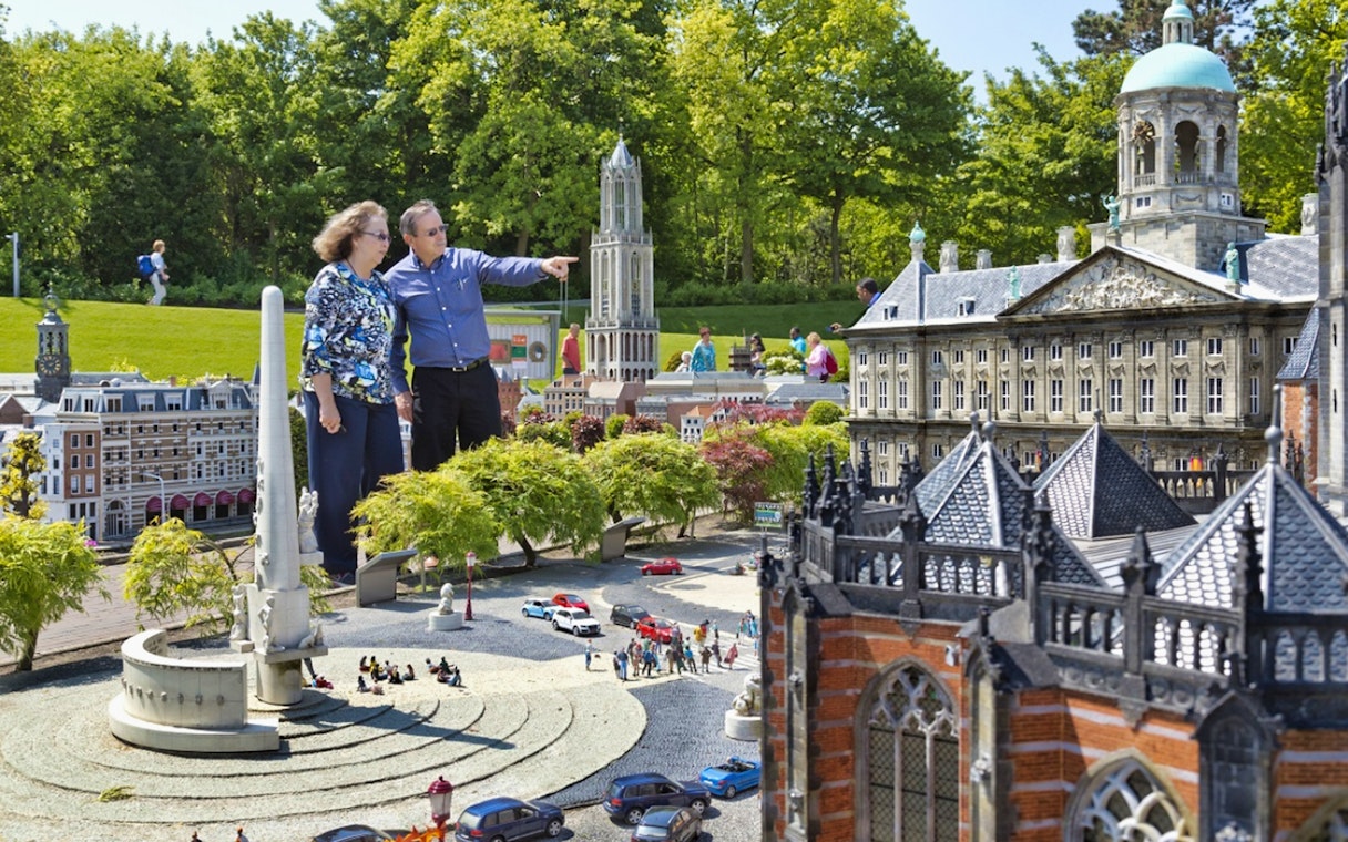 Visitors exploring miniature landmarks at Madurodam Miniature Park in the Netherlands.