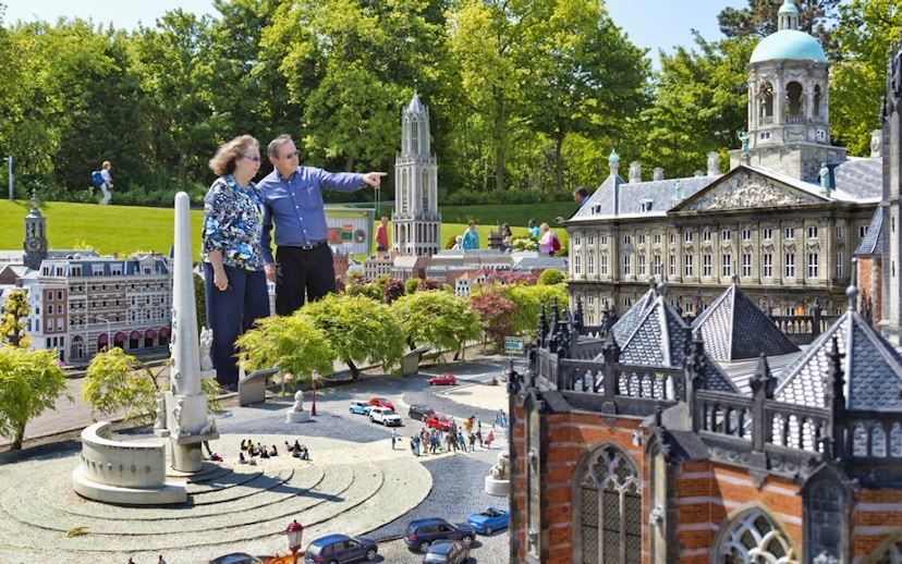 Visitors exploring miniature landmarks at Madurodam Miniature Park in the Netherlands.