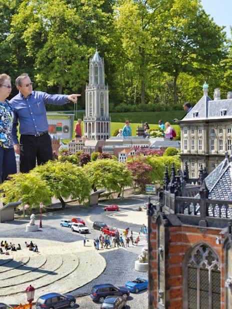 Visitors exploring miniature landmarks at Madurodam Miniature Park in the Netherlands.
