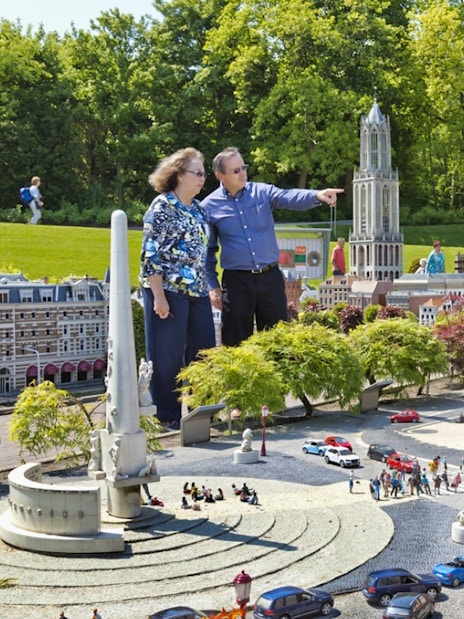 Visitors exploring miniature landmarks at Madurodam Miniature Park in the Netherlands.