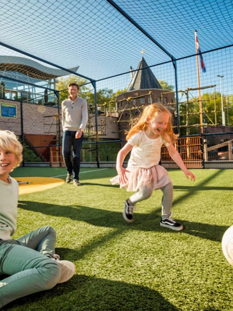 Children playing soccer at Madurodam Miniature Park, Netherlands.