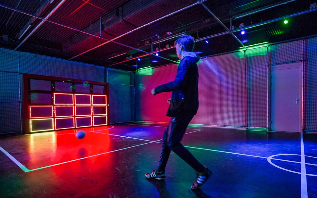 Person playing interactive soccer game at Madurodam Miniature Park.