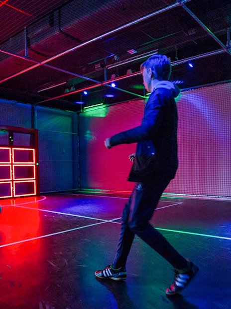 Person playing interactive soccer game at Madurodam Miniature Park.