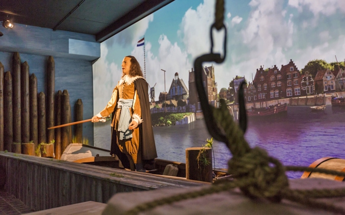 Mannequin in historical Dutch attire at Madurodam Miniature Park exhibit.