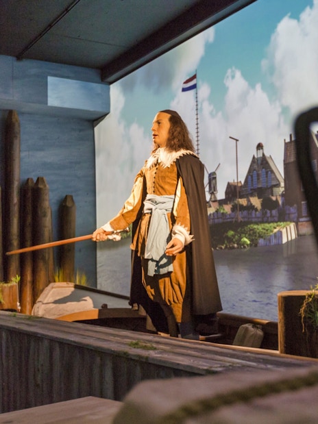 Mannequin in historical Dutch attire at Madurodam Miniature Park exhibit.