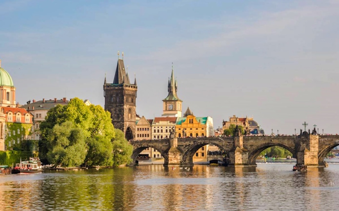 Charles Bridge over Vltava River with Prague's Old Town in the background.