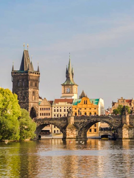Charles Bridge over Vltava River with Prague's Old Town in the background.