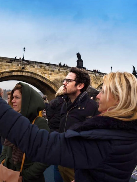 Tourists on a boat cruise near Charles Bridge in Prague.