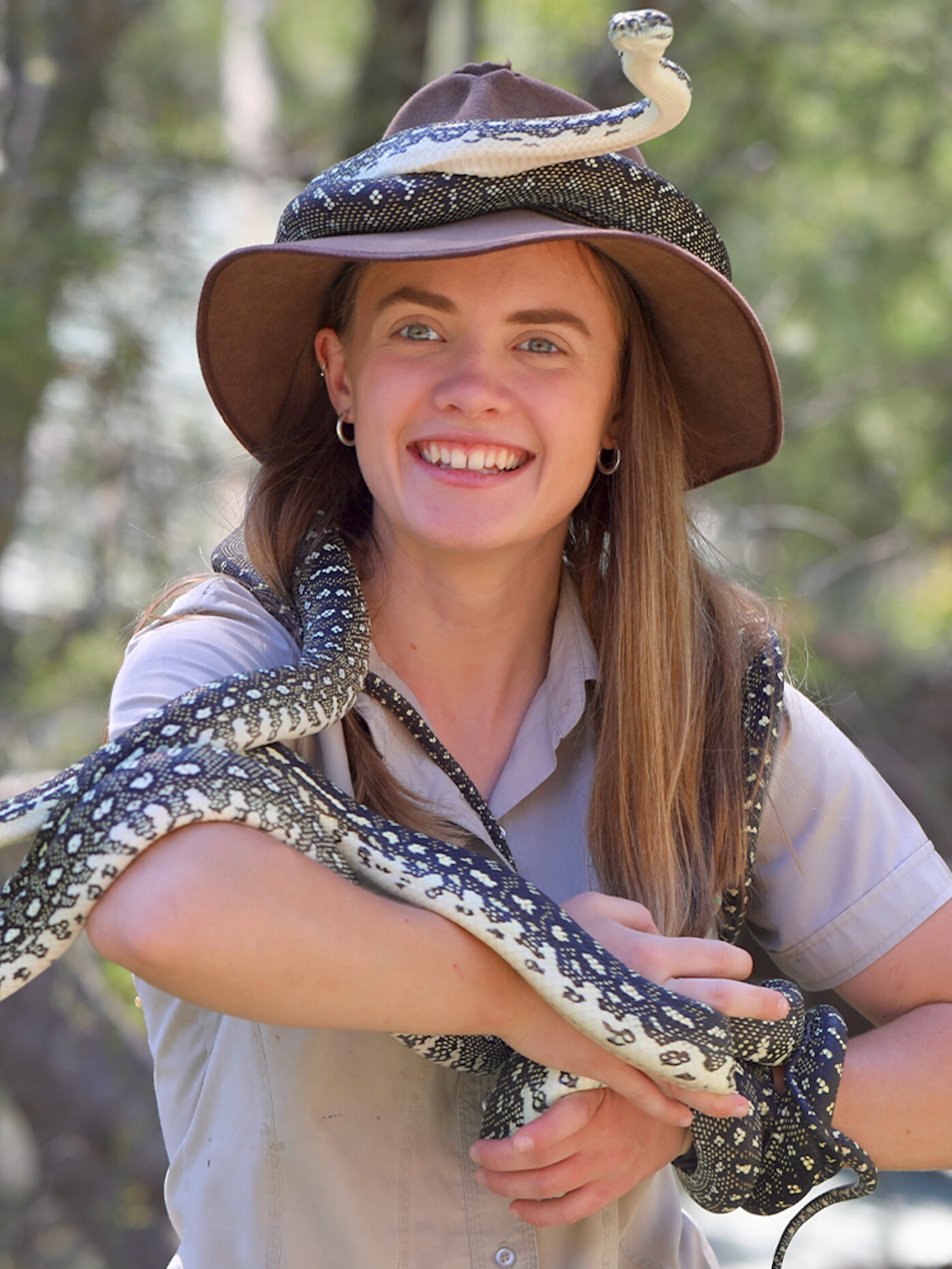 Tour guide holding a snake at Australian Reptile Park.