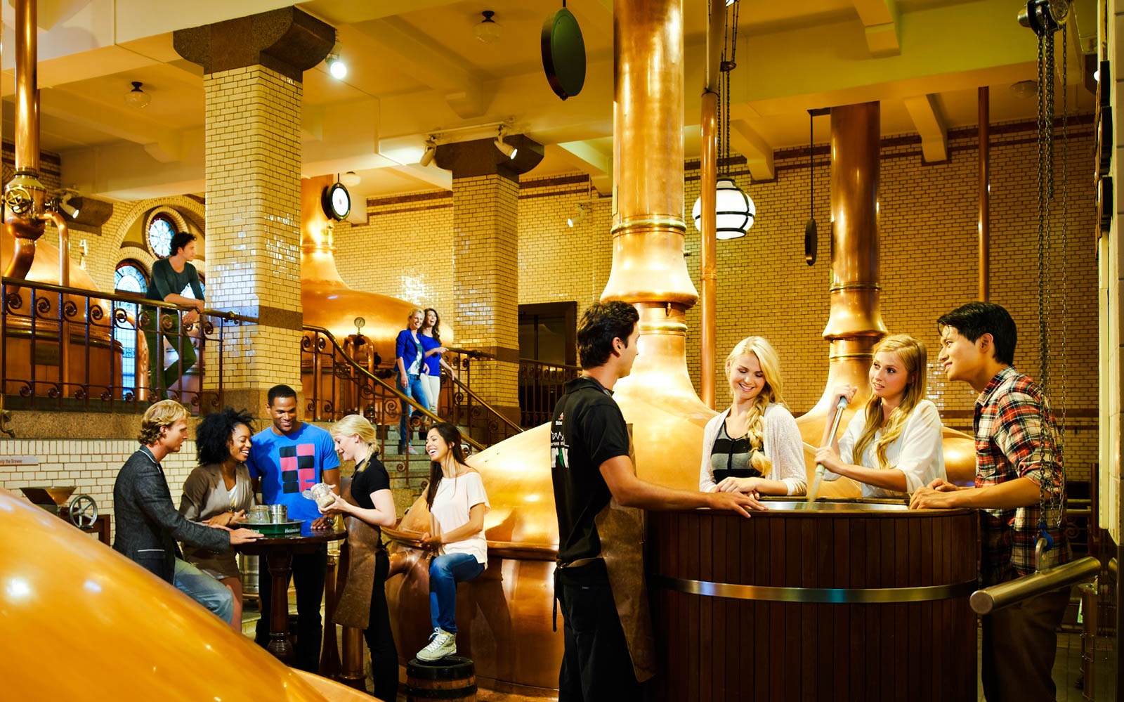 Visitors enjoying the Heineken Experience brewery tour in Amsterdam.