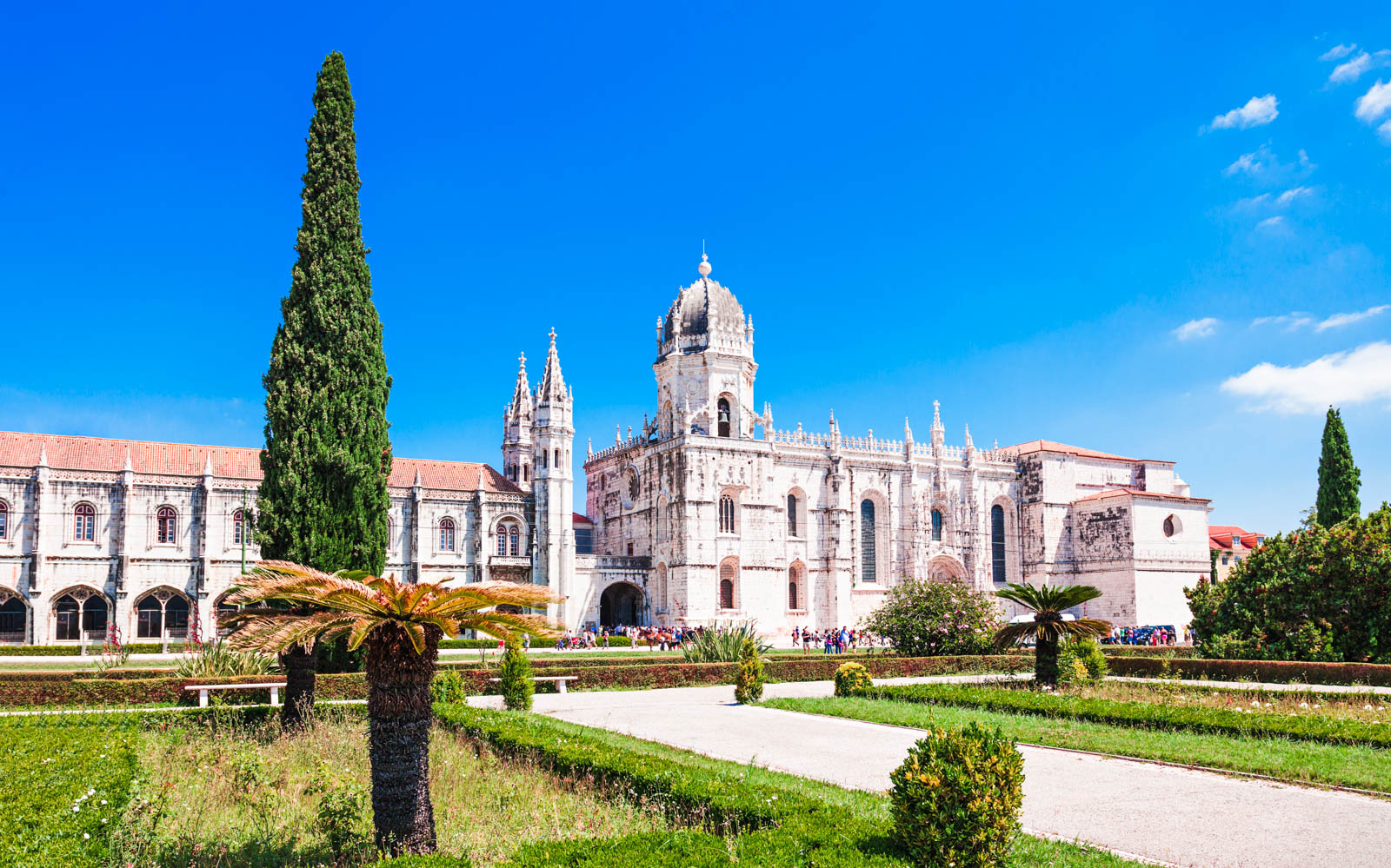 Jeronimos Monastery in Lisbon, Portugal, viewed from the garden on a sunny day.