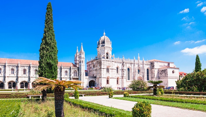 Jeronimos Monastery in Lisbon, Portugal, viewed from the garden on a sunny day.