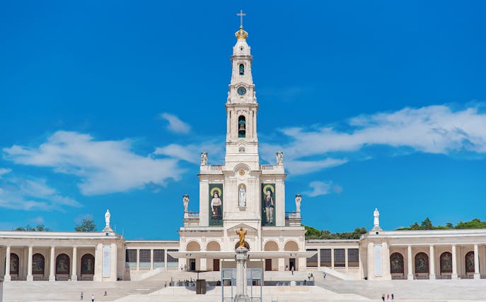Sanctuary of Fátima basilica with blue sky, part of Fatima Highlights Guided Tour from Lisbon.