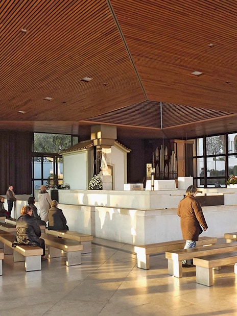 Visitors seated in the Chapel of Apparitions at Fátima during a half-day tour from Lisbon.