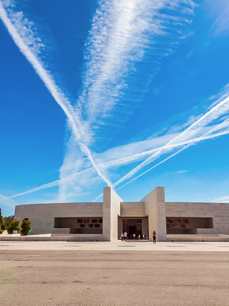 Fátima Sanctuary with modern architecture and cross under blue sky, Portugal.