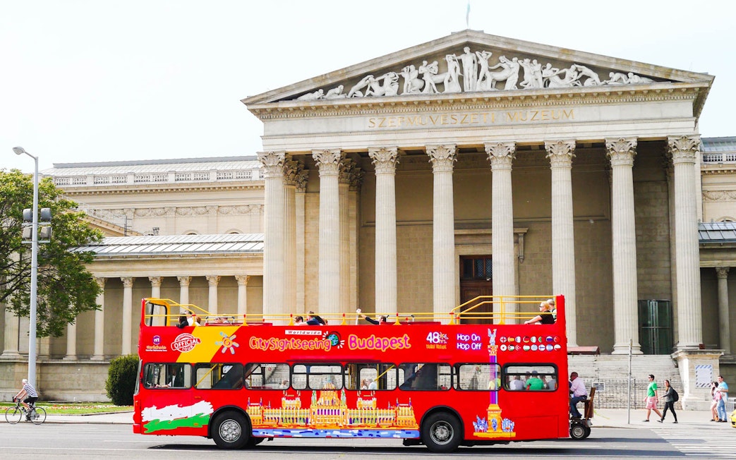 Red Budapest sightseeing bus in front of the Museum of Fine Arts.