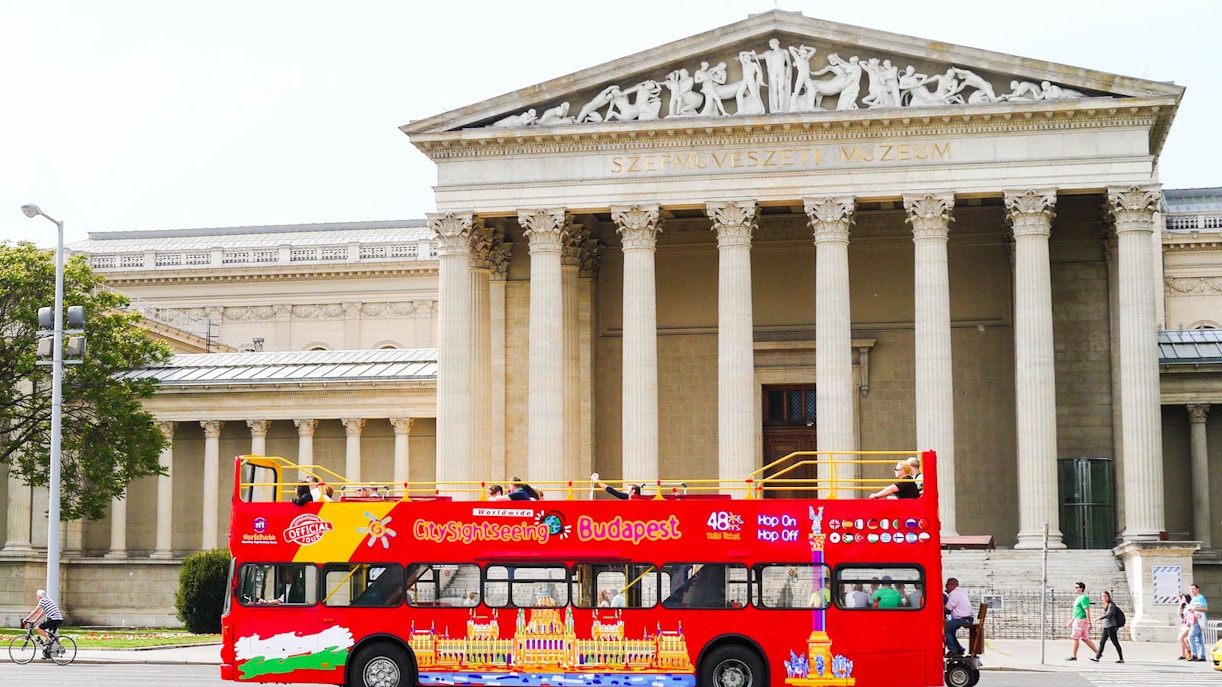 Red Budapest sightseeing bus in front of the Museum of Fine Arts.