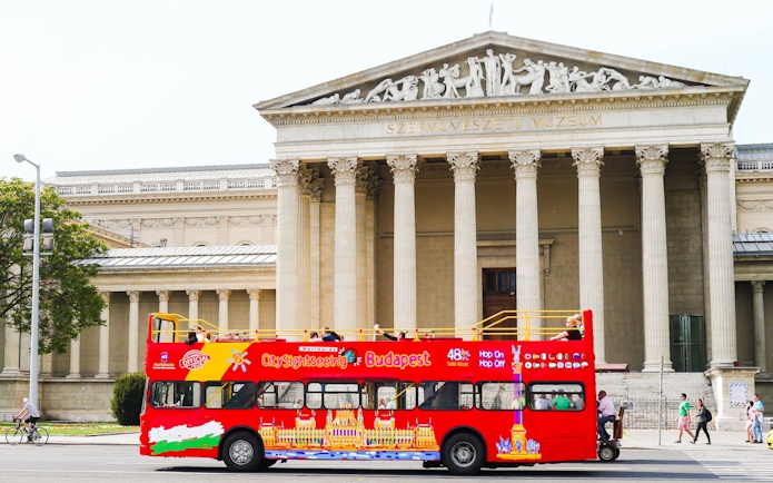 Red Budapest sightseeing bus in front of the Museum of Fine Arts.