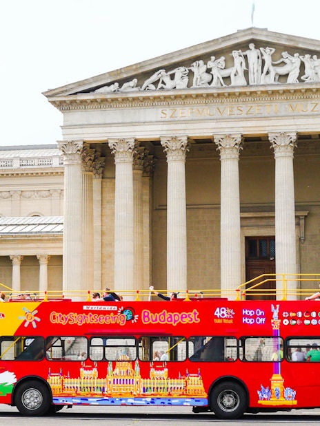 Red Budapest sightseeing bus in front of the Museum of Fine Arts.