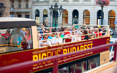 Open-top bus with tourists on a Hop-On Hop-Off tour in Budapest.