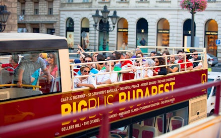 Open-top bus with tourists on a Hop-On Hop-Off tour in Budapest.